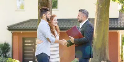 Man and woman shaking a mans hand