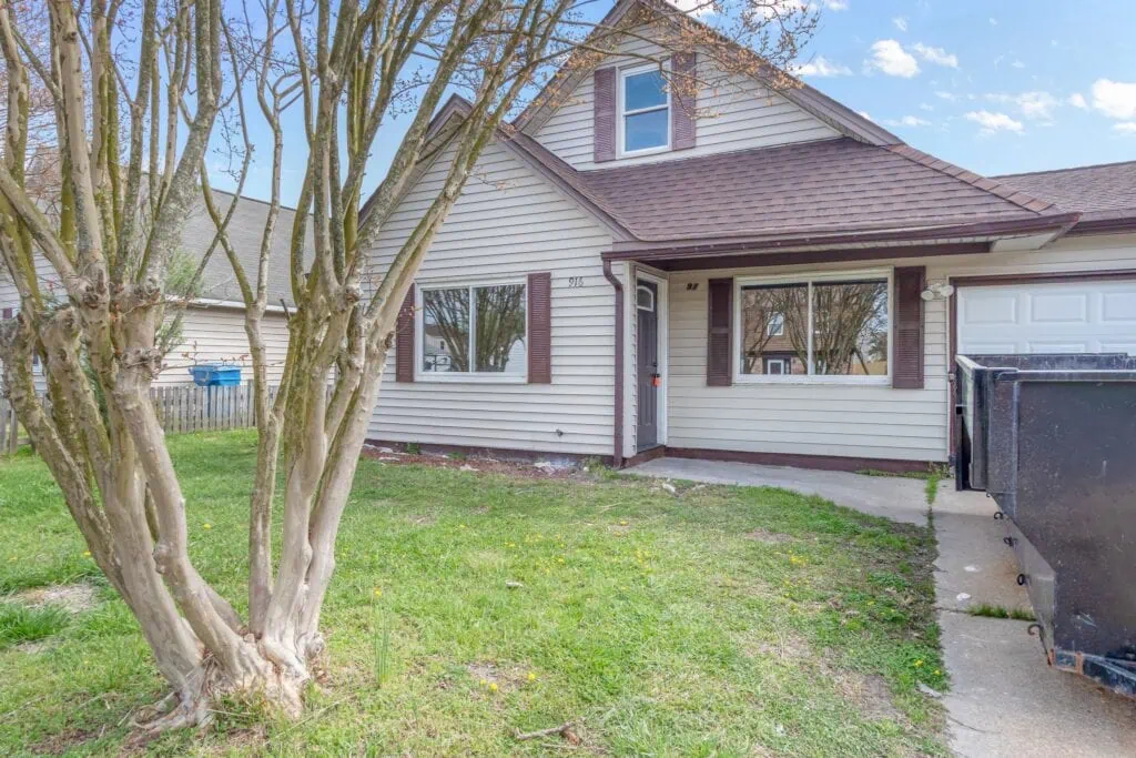 A house in hampton roads with a tree in front of it
