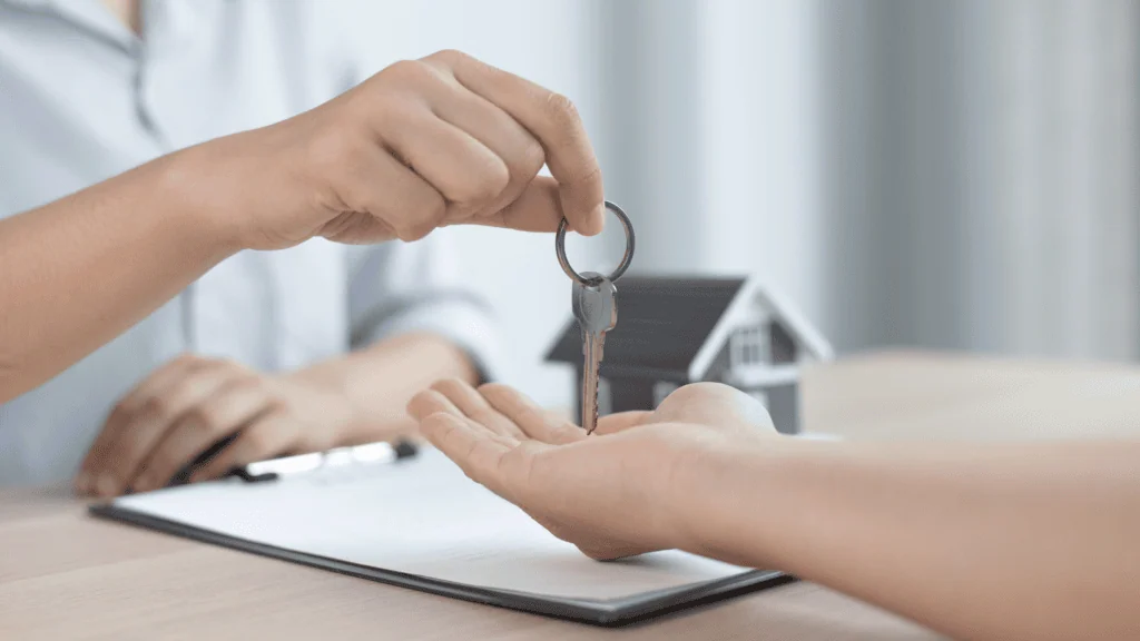 Landlord handing a tenant a room key