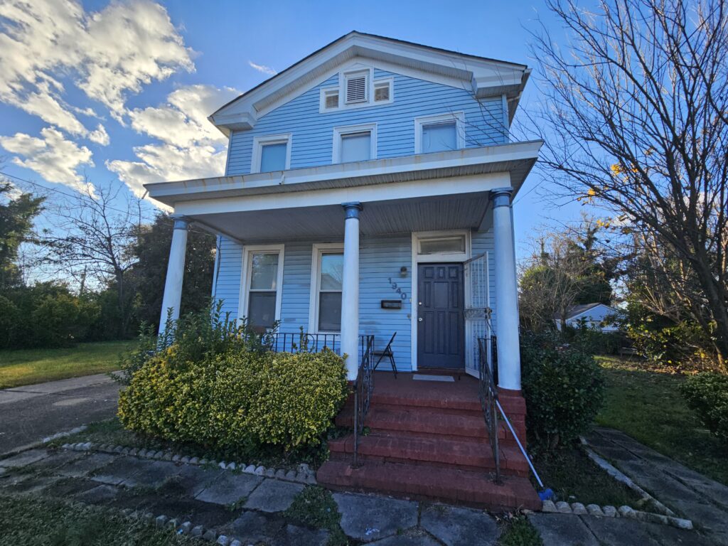 Front of a blue house in Norfolk that we bought for cash