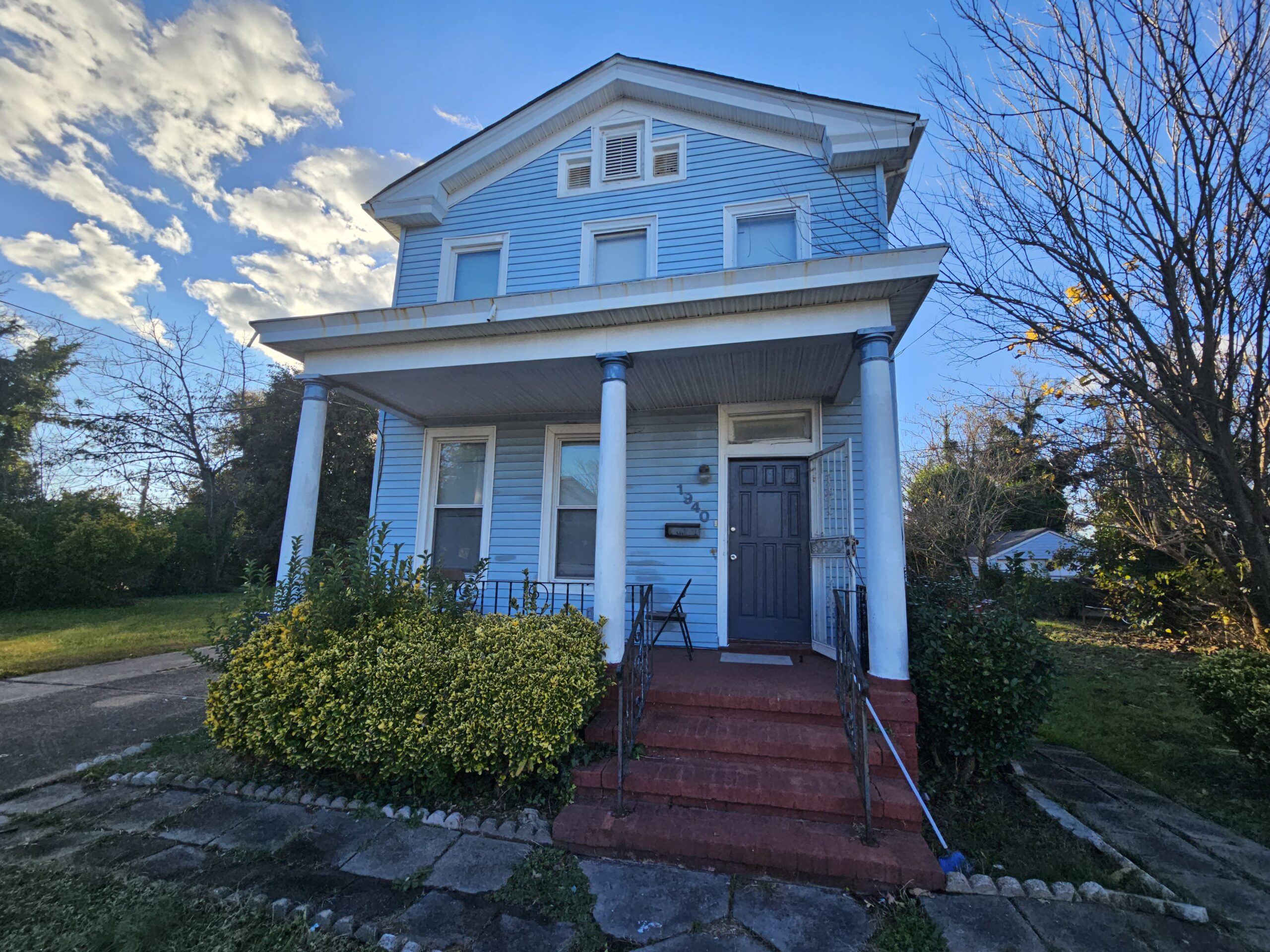 Front of a blue house in Norfolk that we bought for cash