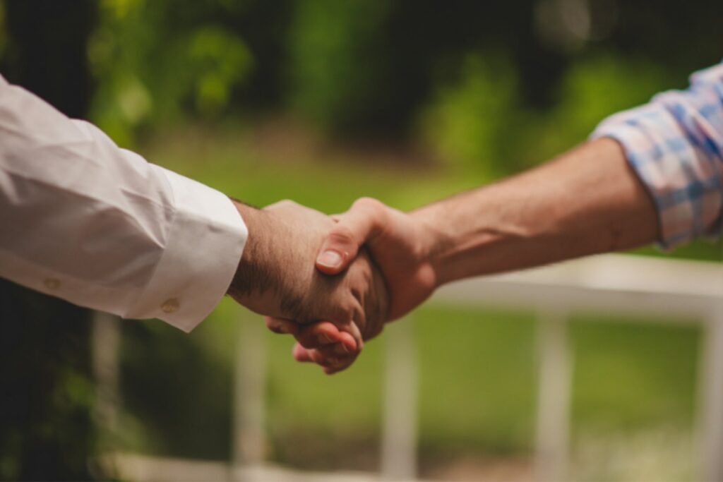 Two people shaking hands after closing