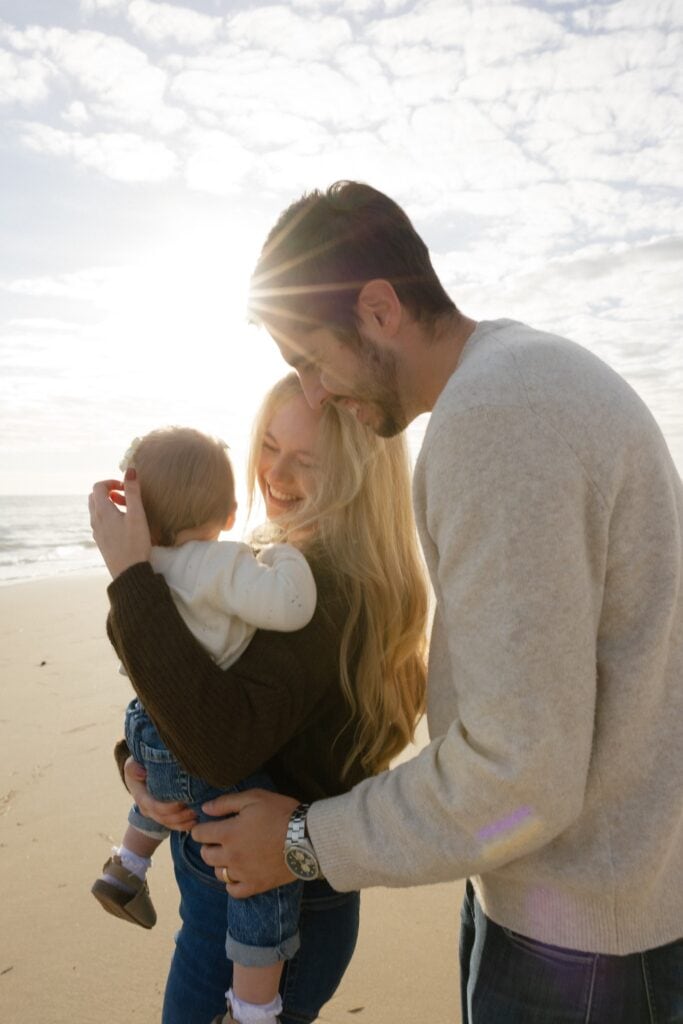 Tyler, his wife and daughter on virginia beach sand
